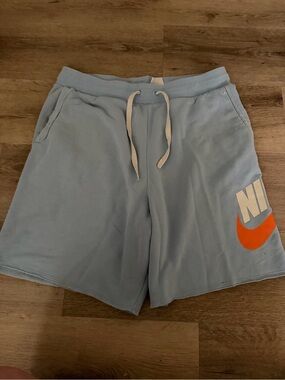 Nike Men’s Light Blue Athletic Shorts with Orange Swoosh
